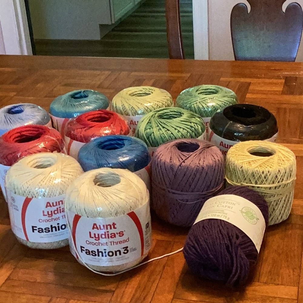 Lot of yarn- yellow and purple barely used with no label, 10 Total rolls.